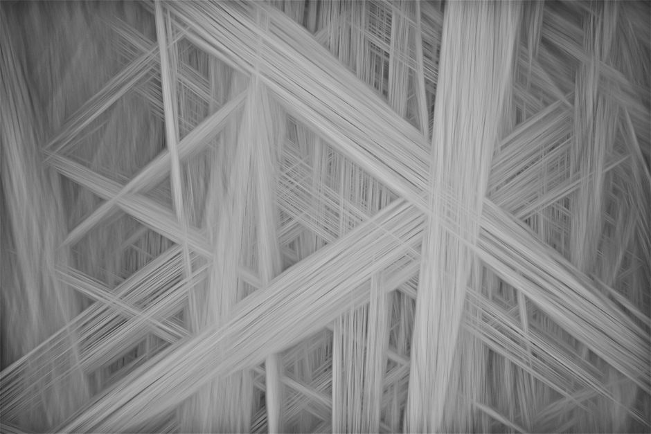Abstract monochrome image showcasing a complex pattern of overlapping diagonal lines, ideal for backgrounds.